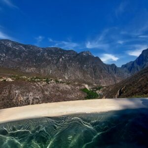 Mountains and water from a natural pool