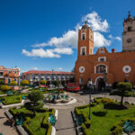 Orange church with a plaza in Hidalgo
