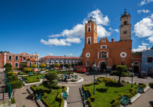 Orange church with a plaza in Hidalgo