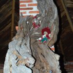 Twisted tree trunk with small duende