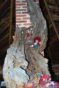 Twisted tree trunk with small duende